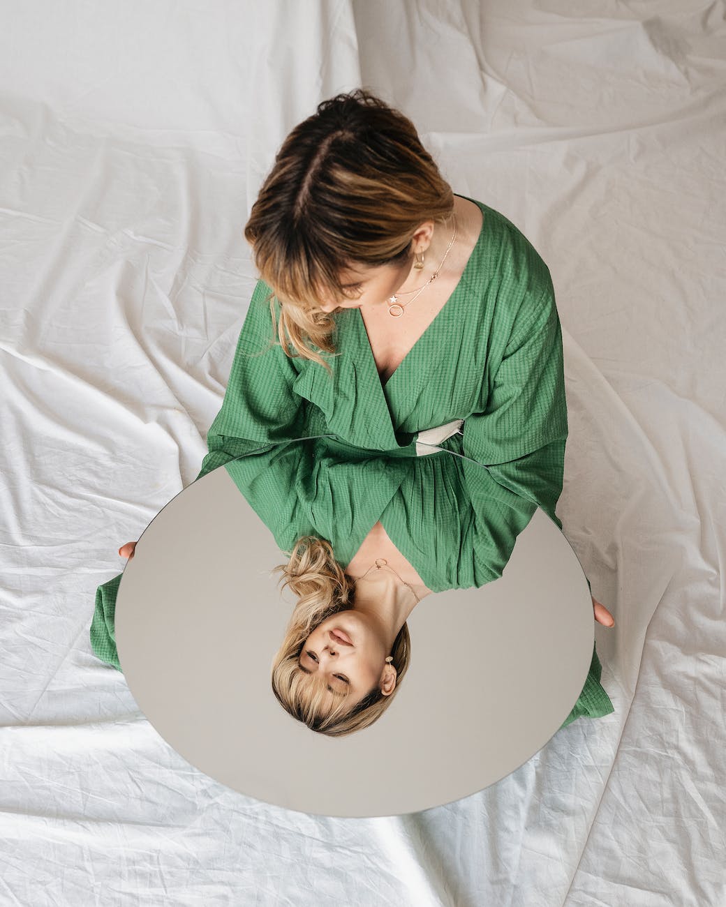 peaceful woman with mirror on textile